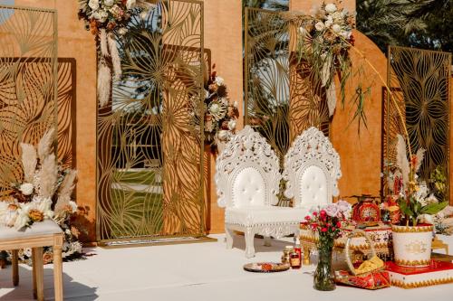 a room filled with white chairs and flowers at DoubleTree by Hilton Orlando Theme Park Resort in Orlando