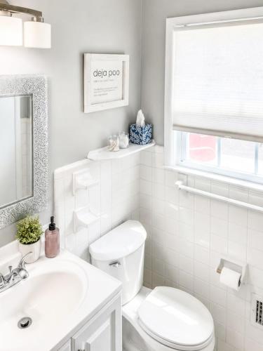 a white bathroom with a toilet and a sink at Tucked away in Tucker in Tucker