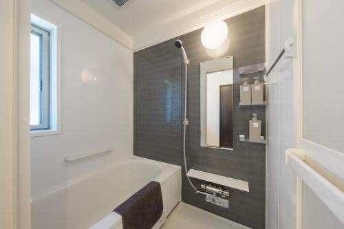 a bathroom with a bath tub and a shower at FUJIMI TOWN HOUSE in Tokyo