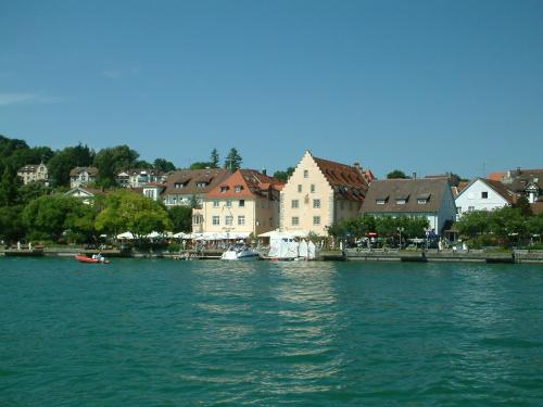 a view of a river with houses and a town at Hotel Strandcafé Dischinger in Überlingen