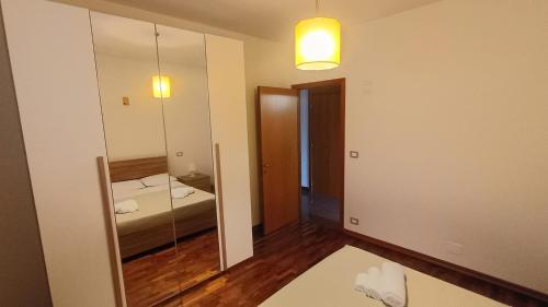 a room with a mirror and a bed in it at Casa FerGi in Amandola