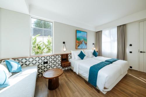 a hotel room with a bed and a couch at Nuho Living in Bingin Beach