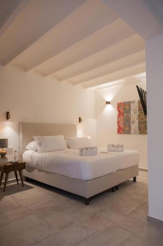 a bedroom with a large white bed in a room at Sant Blai Boutique Hotel - Javea in Jávea