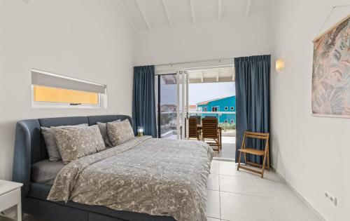 a bedroom with a bed and a view of the ocean at Apartement Punta Azul 6B, Punta Azul Ocean Resort, Westpunt in Westpunt