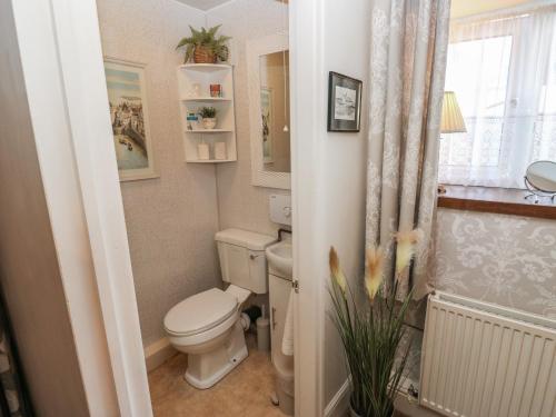 a small bathroom with a toilet and a window at Prospect Cottage in Sowerby Bridge