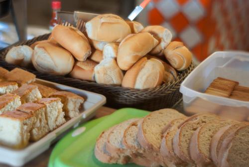 a table topped with baskets of bread and sandwiches at Bonito HI Hostel e Pousada in Bonito