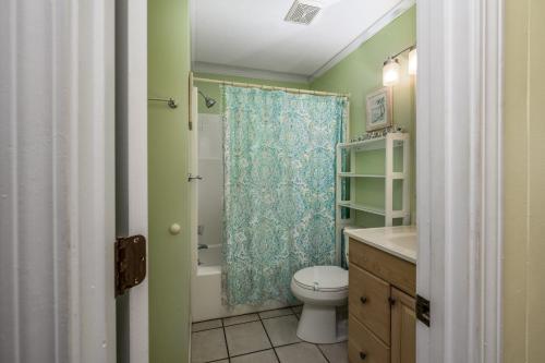 a bathroom with a toilet and a shower curtain at Oceanfront 1BR • Top-Floor Balcony Views • Cherry Grove • Sea Cabin 304-A in Myrtle Beach