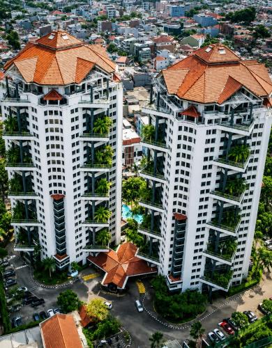 an overhead view of two tall white buildings with orange roofs at Grand Tropic Suites Hotel in Jakarta