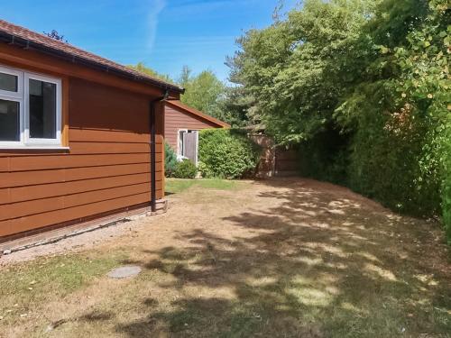a yard next to a house with a tree at Mallard - Uk41033 in Marston