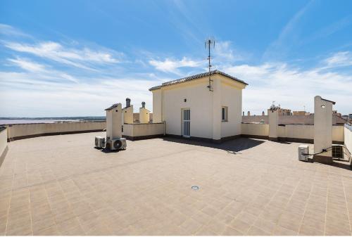 a building on top of a building on a roof at Aparthotel Laguna Rosa in Los Montesinos