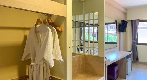 a bathroom with a walk in shower and a mirror at Bunjongburi Hotel in Ban Tha Kup