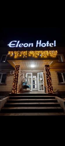 a sign for a hotel with stairs in front at Eleon in Almaty