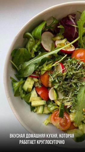 a salad in a white bowl on a table at Eleon in Almaty