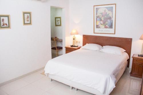 a bedroom with a large white bed with two pillows at Beulah Hotel Boutique in Asuncion