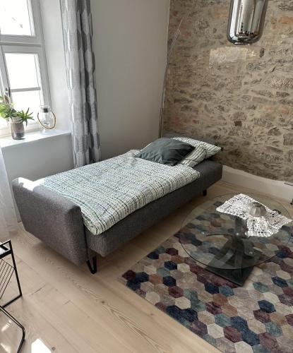 a bedroom with a bed and a glass table at Ferienwohnung im Künstlerhaus KUSCH in Schönsee