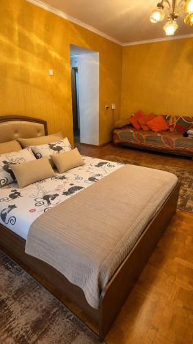 a bedroom with a large bed in a room at Economy - class apartment in Pavlodar