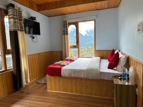 a bedroom with a bed and a large window at Hill Ice Guesthouse & Cafe - Mountain View & Balcony, Tosh in Tosh