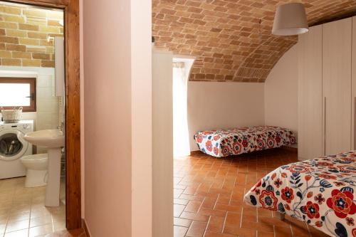 a bedroom with a bed and a sink in a room at La Rusacca Pacentro in Pacentro