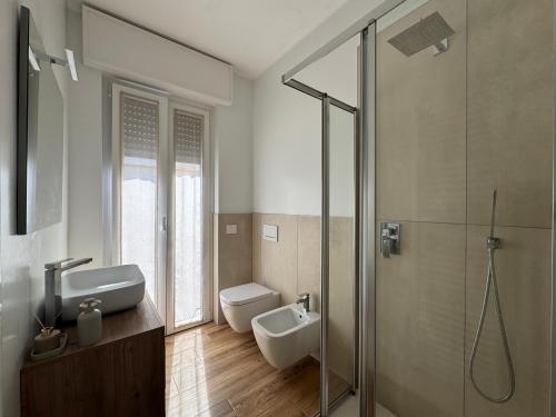a bathroom with a toilet and a sink and a shower at Alta Terrace - Warm Apartment with Large Terrace in Seriate