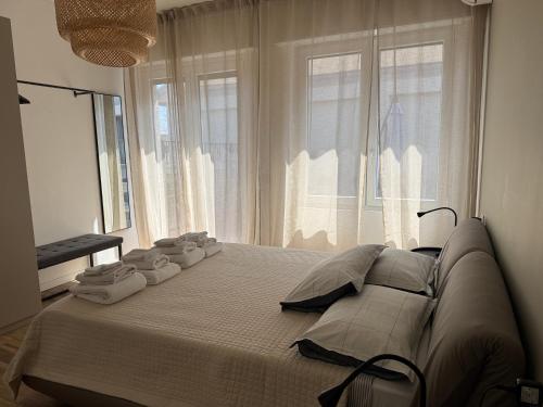 a large bed in a room with a large window at Alta Terrace - Warm Apartment with Large Terrace in Seriate