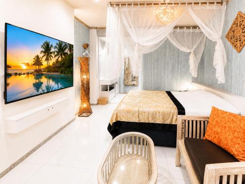 a hotel room with a large tv and a bed at Hotel BaliBali 仙台 in Kōtōdaitōri