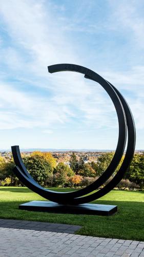 a sculpture of a curved object in a park at C3- Hotel Art De Vivre in Quebec City