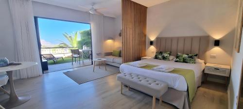 a bedroom with a large bed and a balcony at Maresía Village in Los Realejos