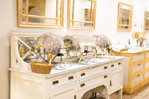 a buffet with plates and bowls on top of it at Las Casas de la Judería de Córdoba in Córdoba