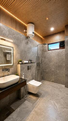 a bathroom with a sink and a toilet at Dharamshila Retreat in Chakrāta