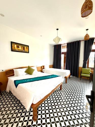 a hotel room with a bed and a couch and a room at An Bang Chic Villa Nguyên Căn in Tân Thành (1)