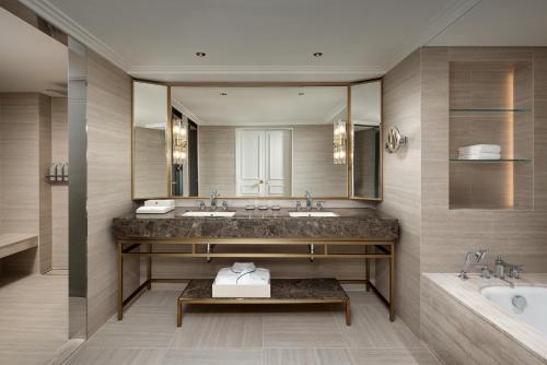 a bathroom with two sinks and a large mirror at THE GRAND LOTTE SEOUL - Formerly known as Lotte Hotel Seoul in Seoul