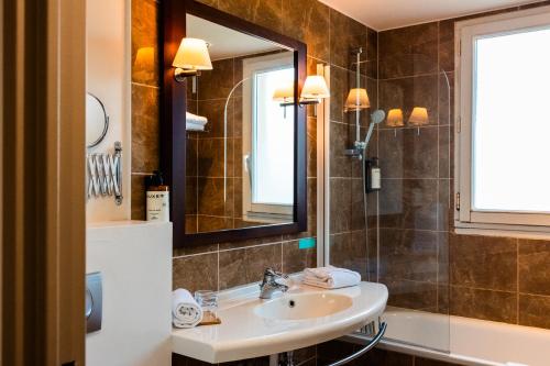 a bathroom with a sink and a mirror at Mercure Rambouillet Relays Du Château in Rambouillet