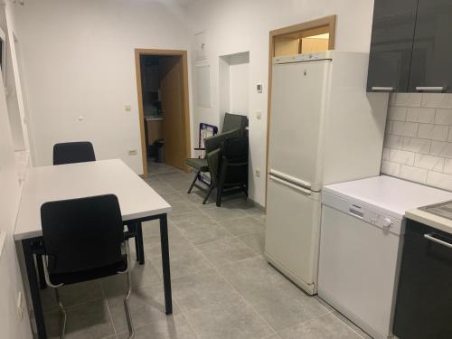 a kitchen with a white refrigerator and a table and chairs at Amor in Klake