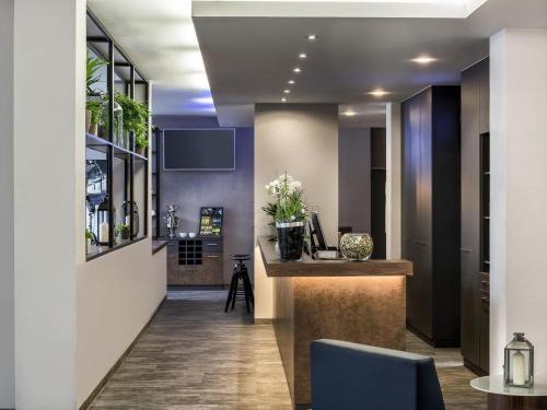 a lobby with a bar in a building at ibis Styles Hotel Gelsenkirchen in Gelsenkirchen