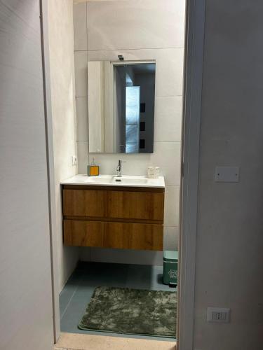 a bathroom with a sink and a mirror at Correri 125 in Modica
