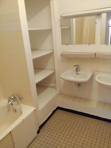 a bathroom with a sink and a toilet and a mirror at Cap Verb Guillestre in Guillestre