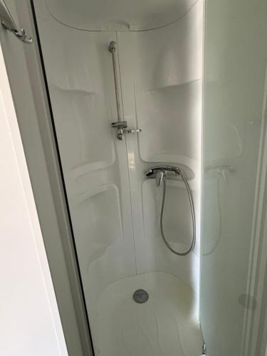 a shower with a glass door in a bathroom at Le Cocon de Galaure in Châteauneuf-de-Galaure