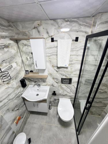 a bathroom with a sink and a toilet at Green Garden Otel in Kemer