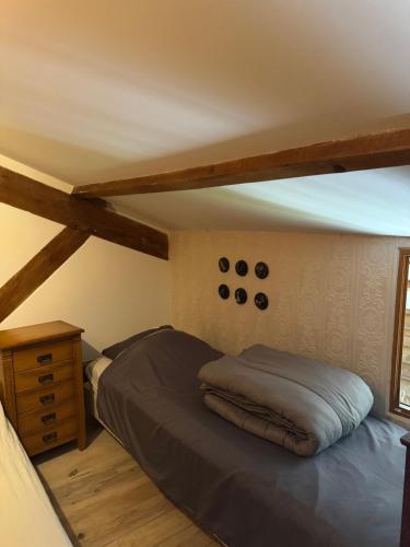 a bedroom with a bed and a wooden dresser at Rimbes Casteljaloux - Gite 6 pers in Casteljaloux