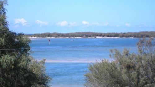 a view of a large body of water with trees at Brighton Le Sands Unit 6 in Golden Beach