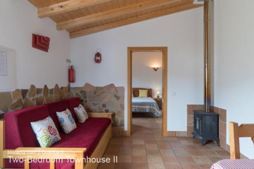 a living room with a couch and a wood stove at Akivillas Aljezur Nature in Aljezur