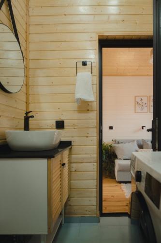 a bathroom with a sink and a mirror at Haiku Cottages in Merisi
