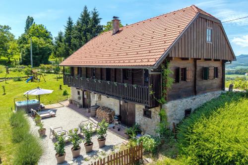 an old house with a red roof and some plants at Country home Lagom in Zagorska Sela