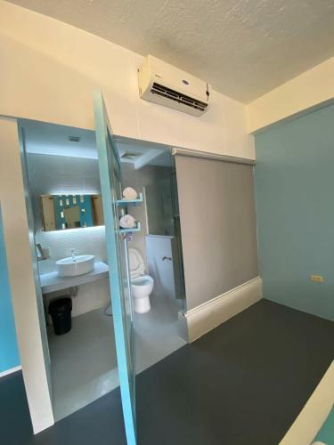 a bathroom with a toilet and a sink at At The Pad Hotel & Villa's in Angeles