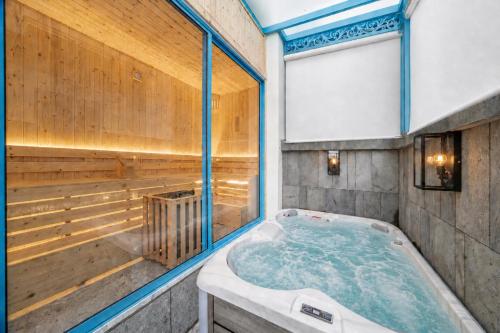 a jacuzzi tub in a room with a window at S Villa Ha Long - City Center, Near Beach - 6BR Private Villa with Pool, Jacuzzi, Sauna, Karaoke in Ha Long