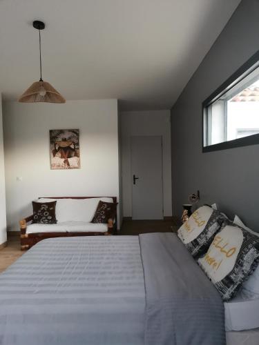 a bedroom with a large bed and a window at Au domaine Isabelle in Lorgues