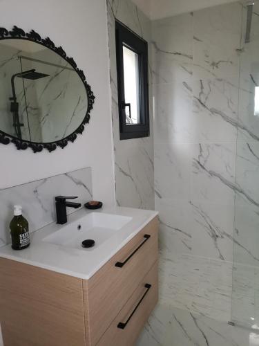 a bathroom with a sink and a mirror at Au domaine Isabelle in Lorgues