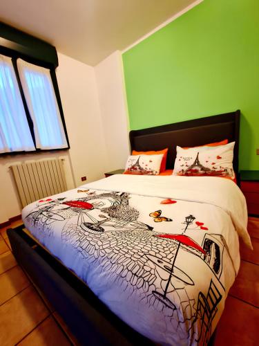 a bedroom with a bed with a comforter on it at Bernina Stop & Go apartment - 30 steps to the red train in Tirano