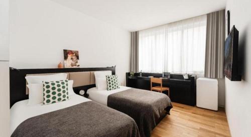 a hotel room with two beds and a window at base-WENDING Service Apartment-Shanghai Xujiahui Location in Shanghai