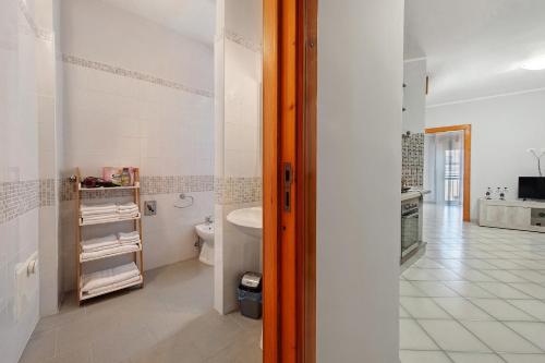 a white bathroom with a toilet and a sink at Stella Del Sud in Squinzano